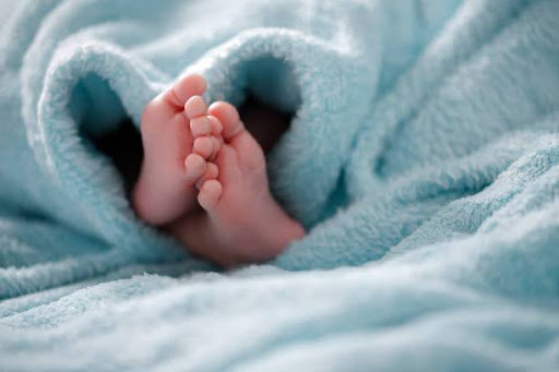 A close-up of tiny baby feet