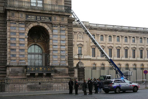 French police officers stand next to a furniture elevator used by robbers to enter the Louvre Museum, on Quai Francois Mitterrand, in Paris on October 19, 2025. Robbers broke in to the Louvre and fled with jewellery on October 19, 2025 morning, a source close to the case said, adding that its value was still being evaluated. A police source said an unknown number of thieves arrived on a scooter armed with small chainsaws and used a goods lift to reach the room they were targeting. (Photo by Dimitar DILKOFF / AFP) (Photo by DIMITAR DILKOFF/AFP via Getty Images)