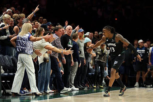 This photo shows Ayo Dosunmu getting the crowd hype after making a bucket.