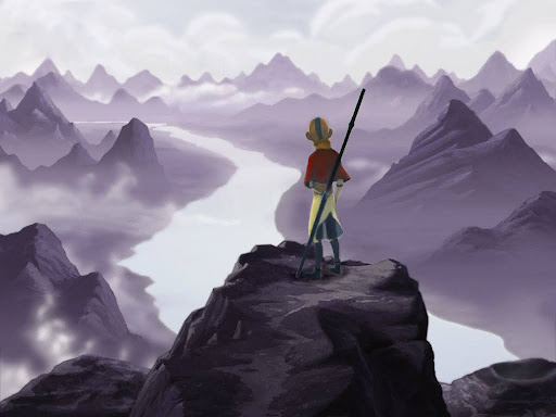 This photo shows the main character of the TV series Avatar: The Last Airbender and the sequel, Legend of Aang, standing on top of rocks looking out at mountains.
