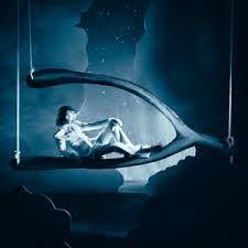 This image shows the new Wishbone Deluxe album cover, with Conan Gray sitting on a large wishbone in blue lighting.